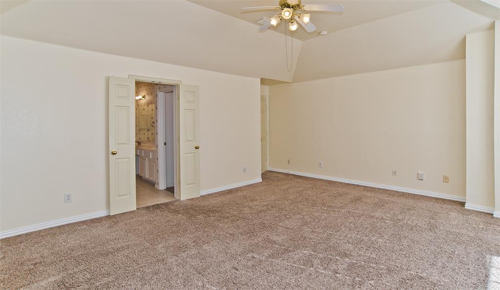 426 Richmond Street Irving, TX 75063 - Photo 22 of 33 a view of an empty room with a chandelier fan