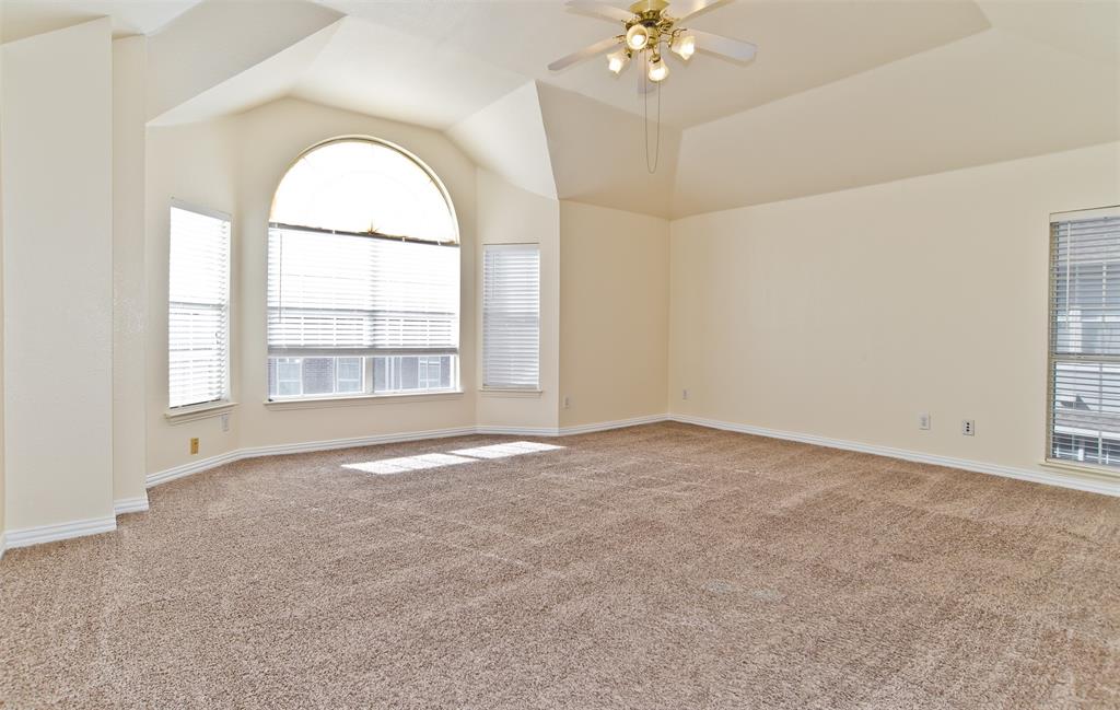 426 Richmond Street Irving, TX 75063 - Photo 23 of 33 an empty room with windows and chandelier fan