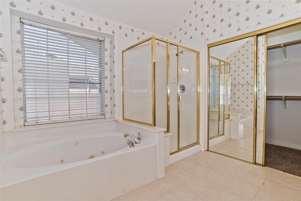 426 Richmond Street Irving, TX 75063 - Photo 27 of 33 a bathroom with a bathtub and a shower