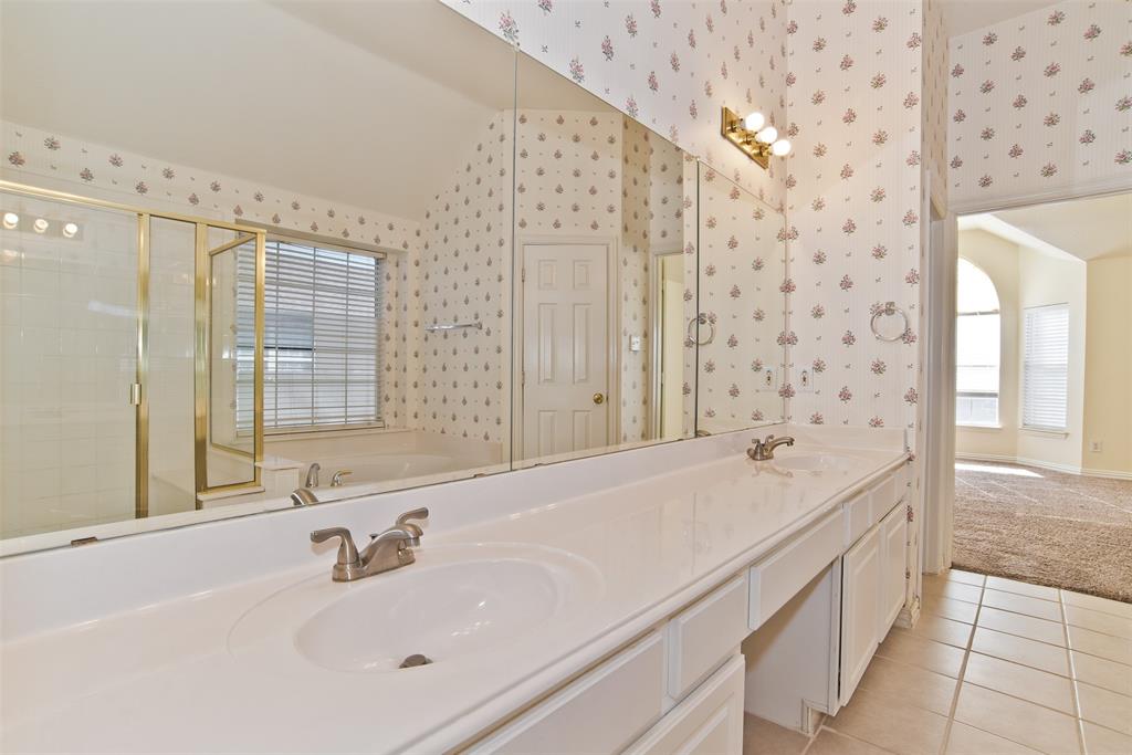 426 Richmond Street Irving, TX 75063 - Photo 28 of 33 a bathroom with a granite countertop sink a large mirror and a bathtub
