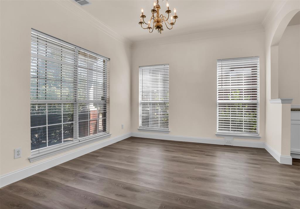 426 Richmond Street Irving, TX 75063 - Photo 4 of 33 a view of an empty room with wooden floor and a window