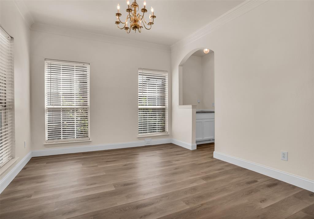 426 Richmond Street Irving, TX 75063 - Photo 5 of 33 a view of an empty room with wooden floor and a window