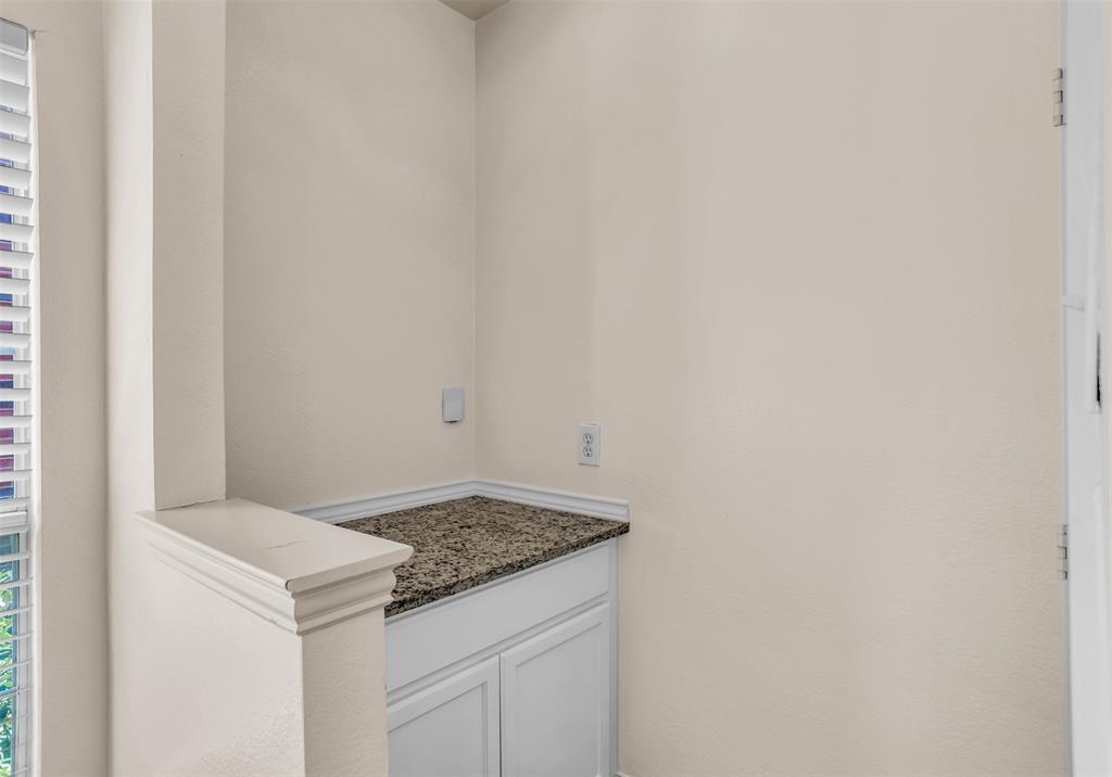 426 Richmond Street Irving, TX 75063 - Photo 7 of 33 a utility room with granite countertop