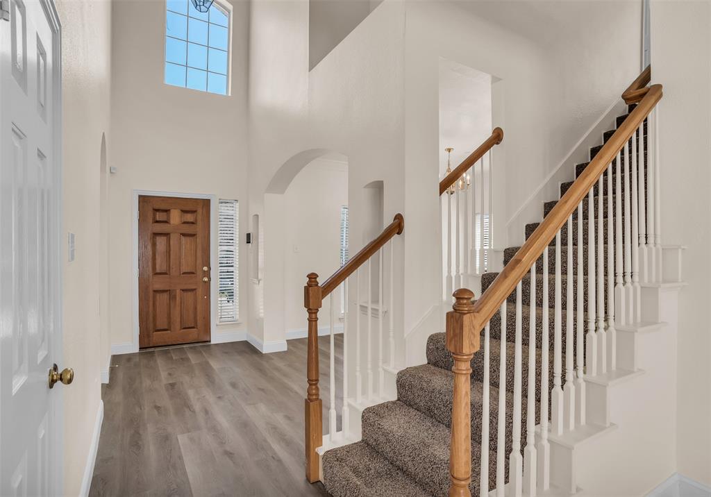 426 Richmond Street Irving, TX 75063 - Photo 8 of 33 a view of staircase with lots of frames on wall and wooden floor