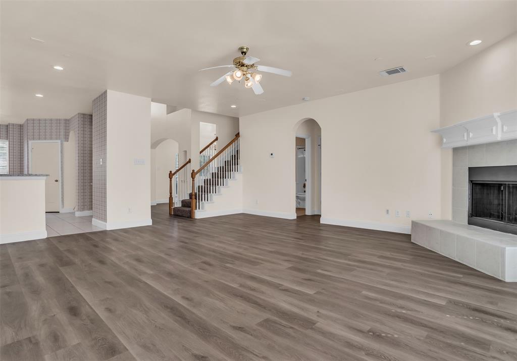 426 Richmond Street Irving, TX 75063 - Photo 9 of 33 a view of an empty room with wooden floor and a fireplace