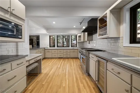 a kitchen with stainless steel appliances granite countertop wooden cabinets stove and sink