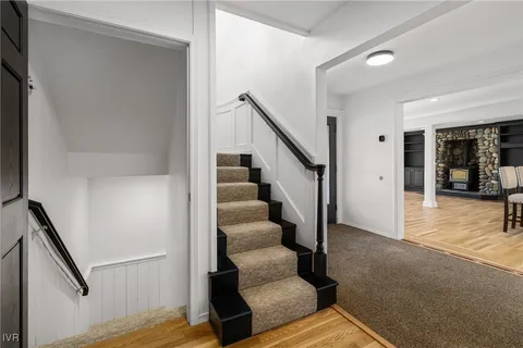 a view of entryway and hall with wooden floor