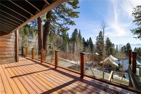 a view of a balcony with wooden floor and fence