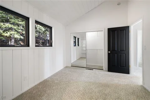 an empty room with windows and closet