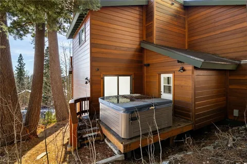 a patio with table and chairs and potted plants