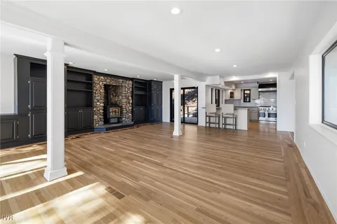 a view of a room with wooden floor and furniture