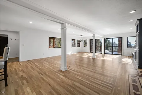 a view of a livingroom with wooden floor and large window
