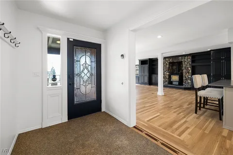a view of a hallway to dining room with wooden floor and windows