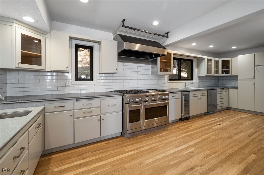 1014 Saturn Court Incline Village, NV 89451 - Photo 9 of 41 a kitchen with stainless steel appliances granite countertop a stove top oven a sink dishwasher and white cabinets with wooden floor