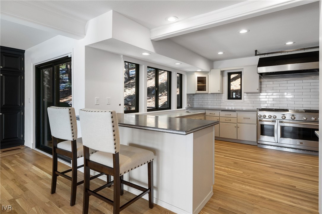 1014 Saturn Court Incline Village, NV 89451 - Photo 10 of 41 a kitchen with stainless steel appliances granite countertop a stove top oven a sink a dining table and chairs