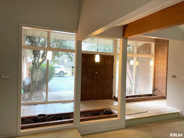 a view of a room with a floor to ceiling window