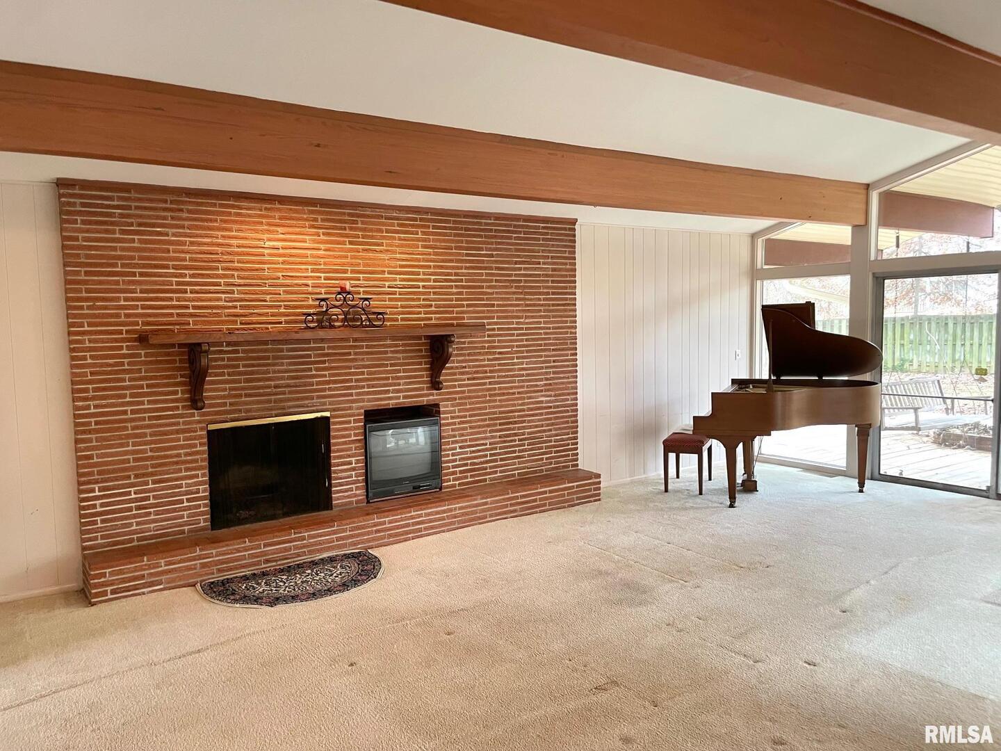 7 Pinewood Drive Carbondale, IL 62901 - Photo 4 of 20 a living room with furniture a fireplace and a large window