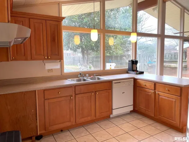 a kitchen with a sink and large window