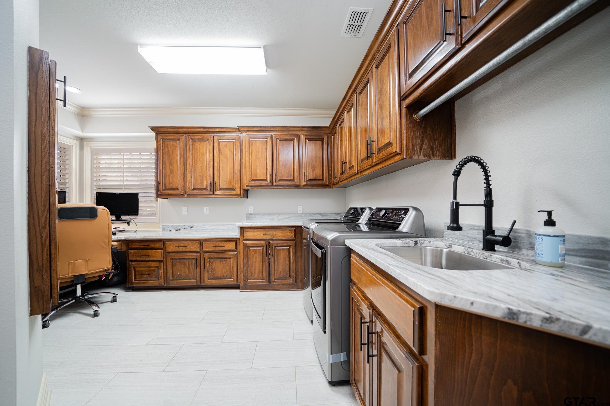 3841 Castle Ridge Drive Longview, TX 75605 - Photo 15 of 42 a kitchen with granite countertop a sink stainless steel appliances and cabinets