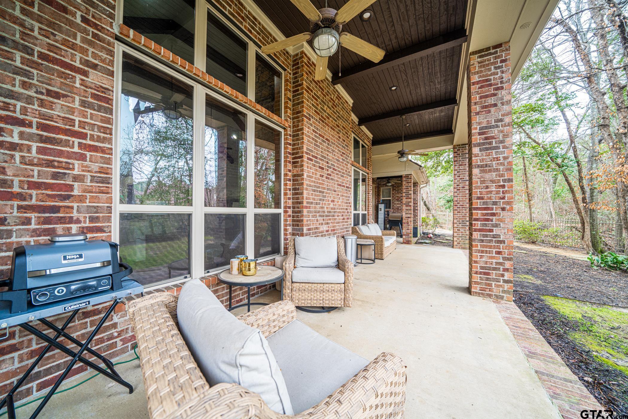 3841 Castle Ridge Drive Longview, TX 75605 - Photo 18 of 42 a view of a patio with a table and chairs