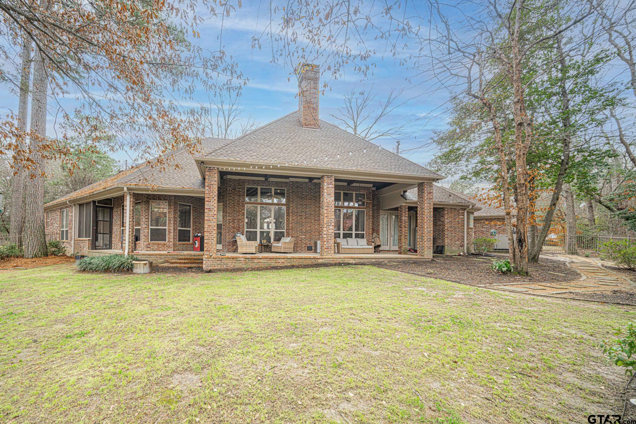3841 Castle Ridge Drive Longview, TX 75605 - Photo 20 of 42 a front view of a house with swimming pool and porch with furniture