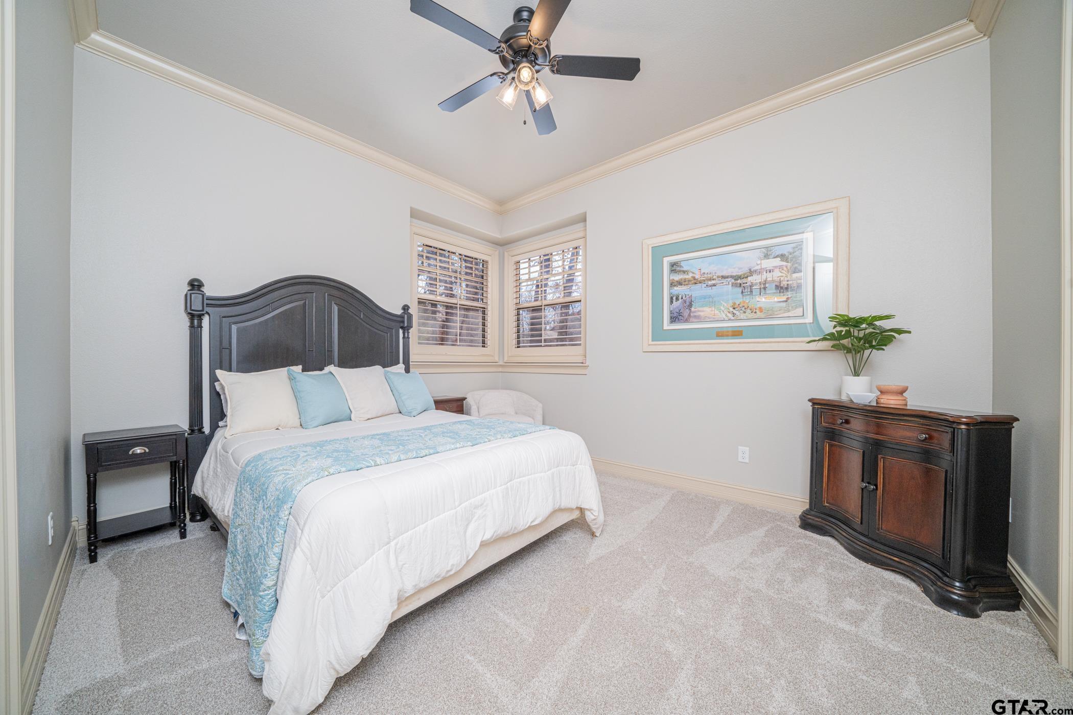 3841 Castle Ridge Drive Longview, TX 75605 - Photo 22 of 42 a bedroom with a bed and a chandelier