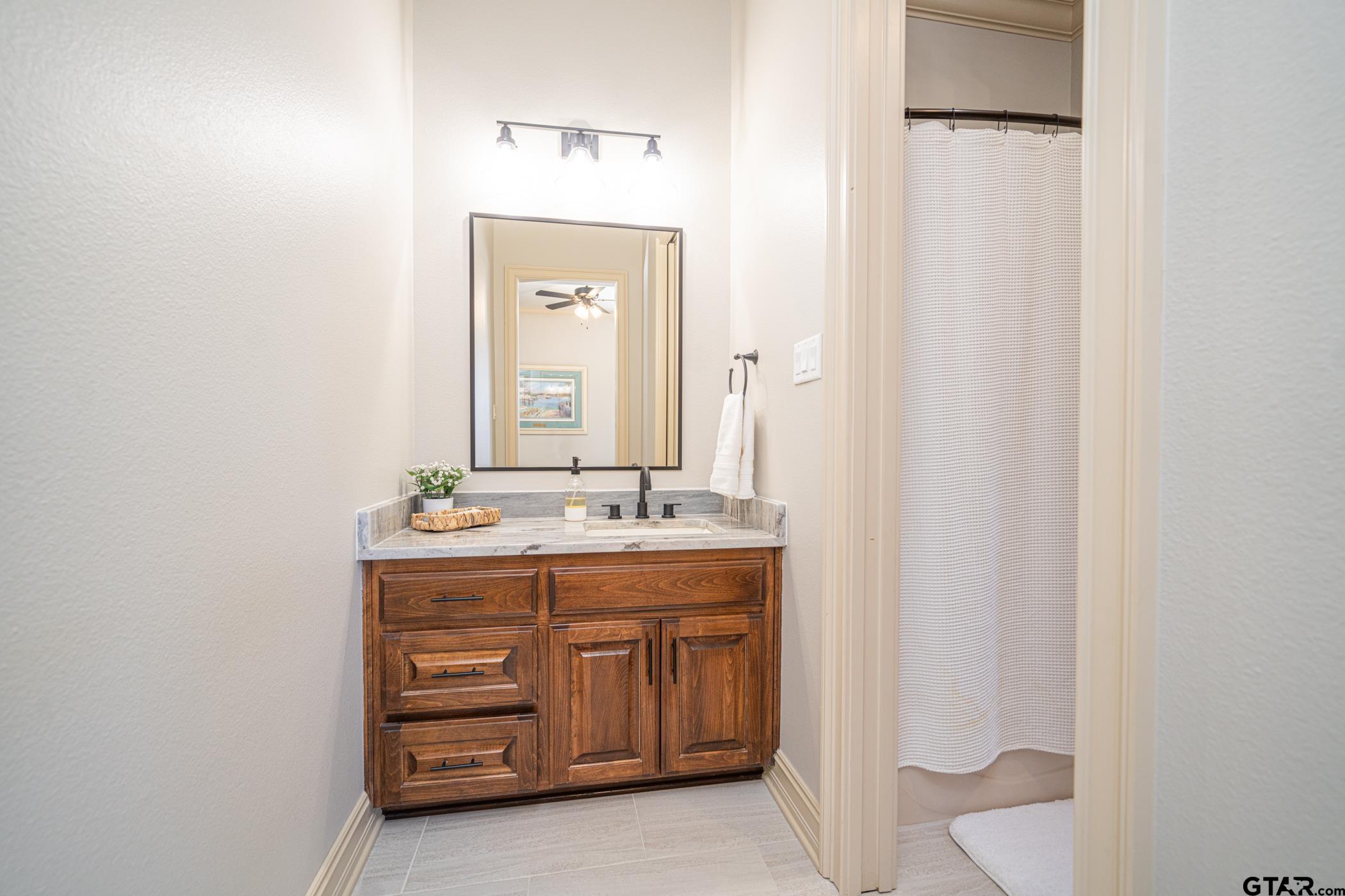 3841 Castle Ridge Drive Longview, TX 75605 - Photo 23 of 42 a bathroom with a granite countertop sink and a mirror