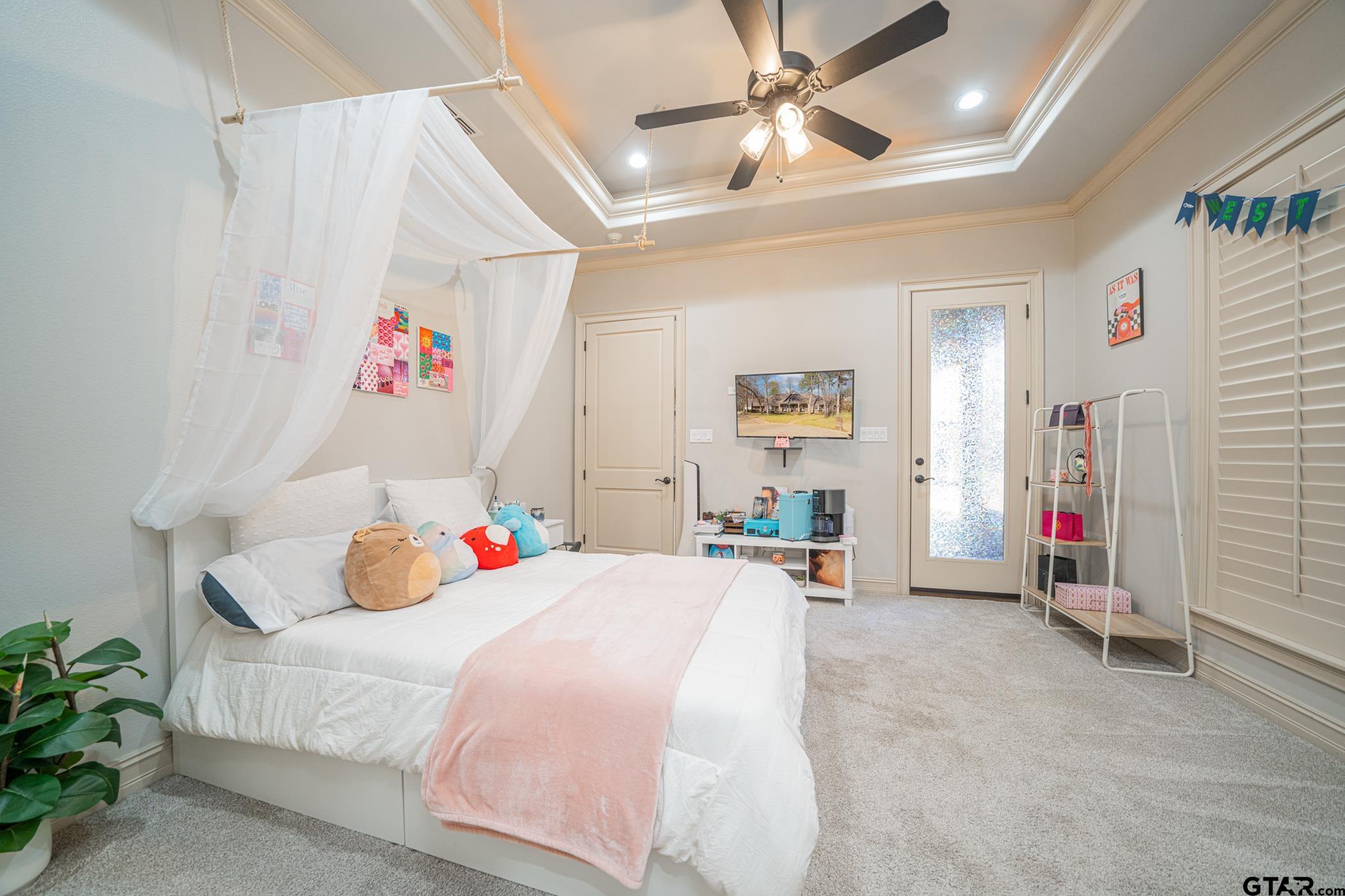 3841 Castle Ridge Drive Longview, TX 75605 - Photo 28 of 42 a bedroom with a bed and a chandelier