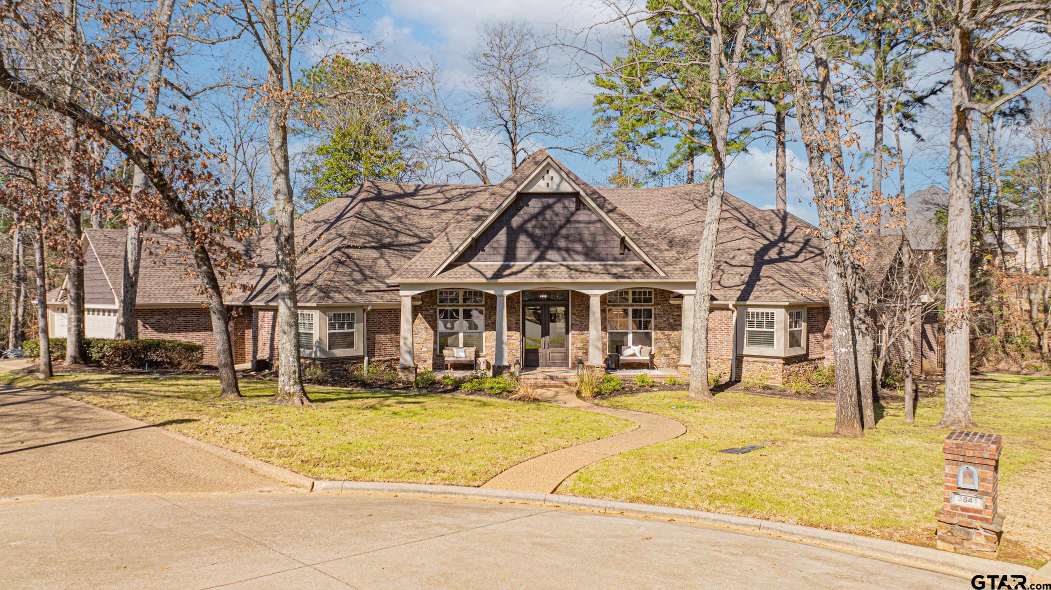 3841 Castle Ridge Drive Longview, TX 75605 - Photo 41 of 42 a front view of a building with a garden