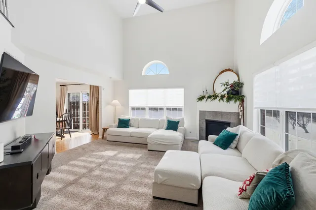 a living room with furniture a fireplace and a flat screen tv