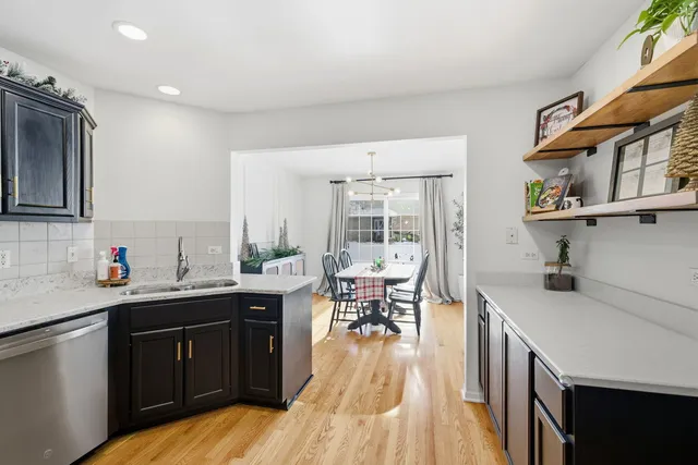 a kitchen with a sink a stove and cabinets
