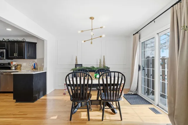 a view of a dining room with furniture wooden floor and chandelier