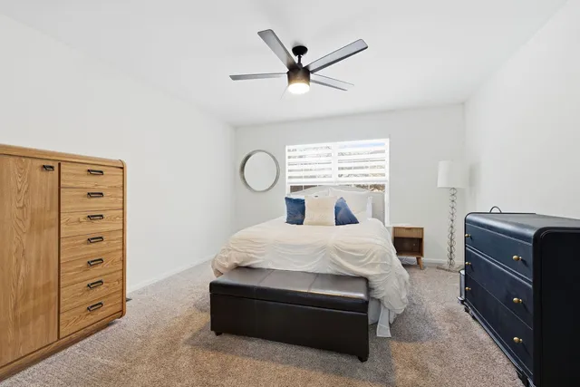 a bedroom with a bed and a dresser