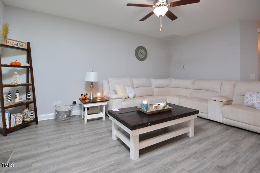195 Timberwind Road Franklinton, NC 27525 - Photo 8 of 28 a living room with furniture and a wooden floor