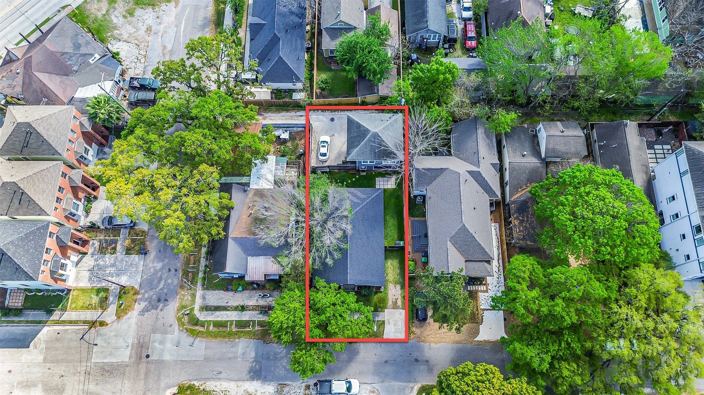 210 Tabor Street Houston, TX 77009 - Photo 17 of 18 This aerial photo showcases a quaint residential neighborhood with tree-lined streets. The homes vary in style and are closely spaced, creating a cozy community feel. Lush greenery surrounds the area, contributing to a serene atmosphere.