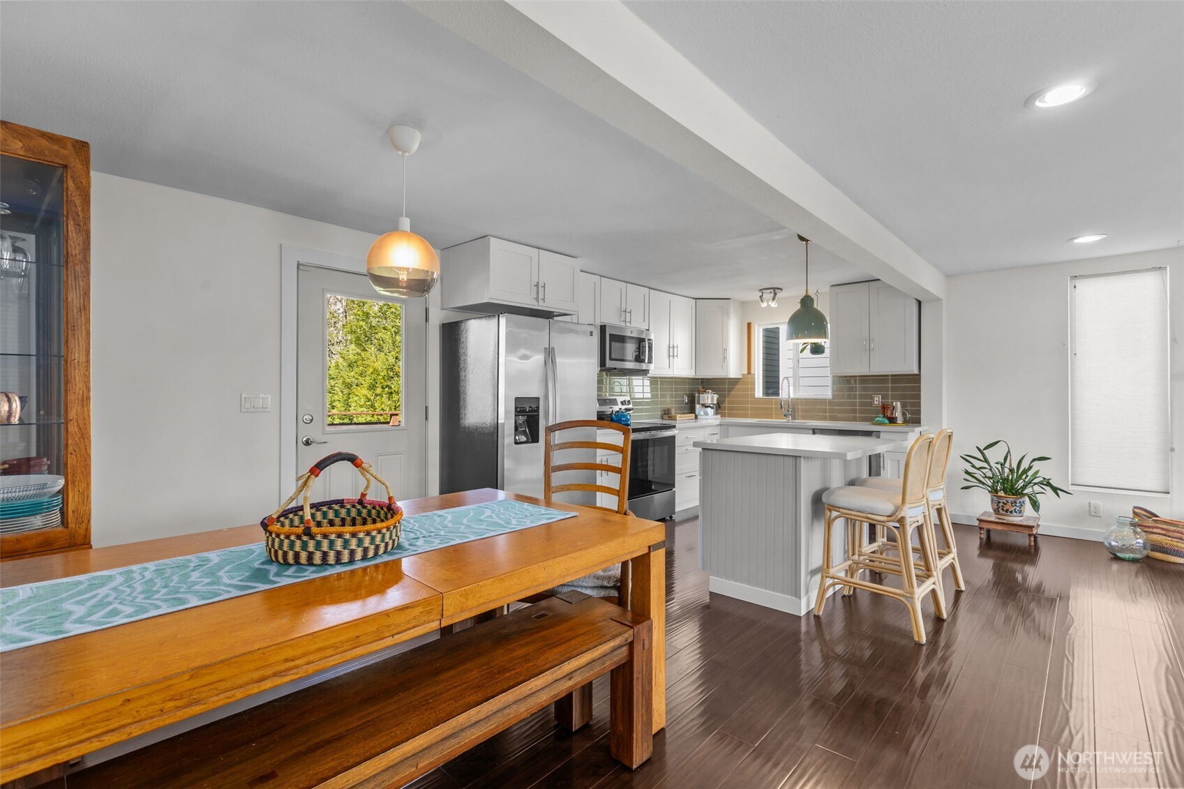 215 Hubbard Road Lynnwood, WA 98036 - Photo 12 of 40 a kitchen with a table chairs refrigerator and microwave