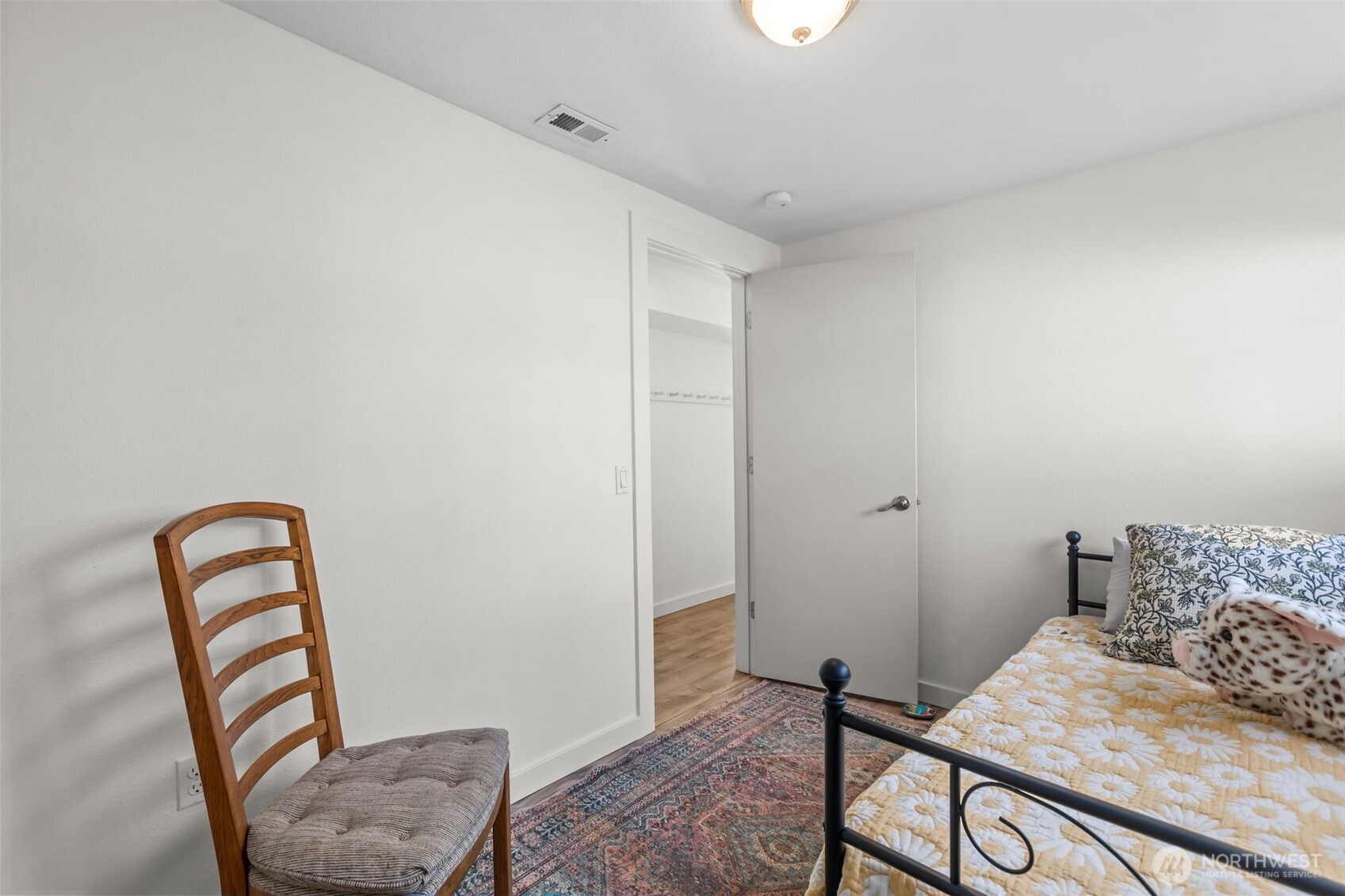 215 Hubbard Road Lynnwood, WA 98036 - Photo 24 of 40 a bedroom with a bed and wooden floor