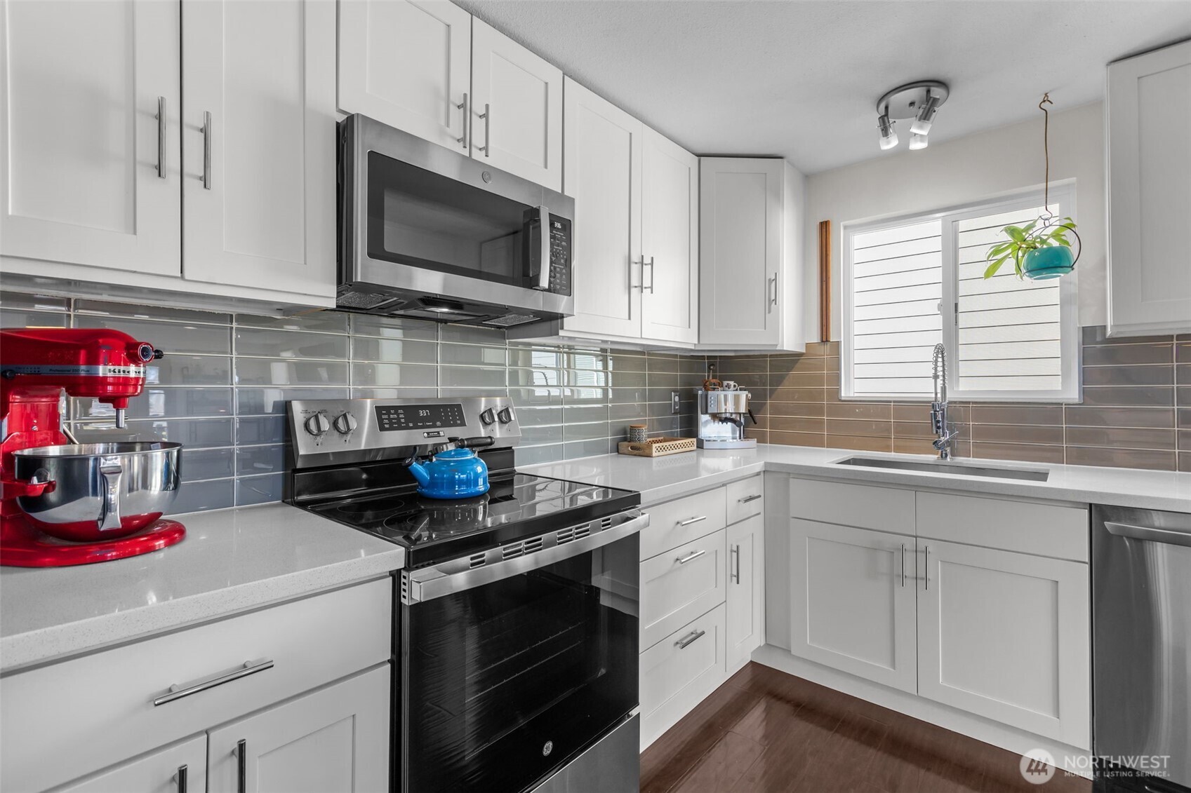 215 Hubbard Road Lynnwood, WA 98036 - Photo 7 of 40 a kitchen with a sink dishwasher stove and white cabinets
