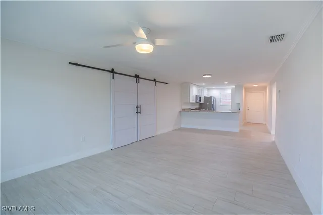 a view of an empty room with wooden floor