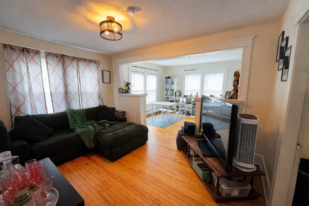 328 Brooks Street Worcester, MA 01606 - Photo 19 of 32 a living room with furniture a fireplace and a window