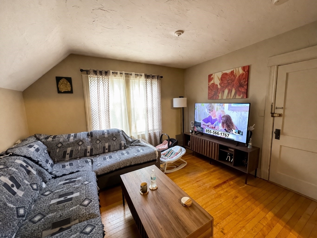 328 Brooks Street Worcester, MA 01606 - Photo 26 of 32 a living room with furniture and a flat screen tv