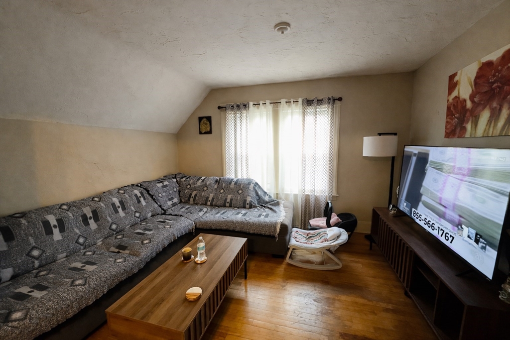 328 Brooks Street Worcester, MA 01606 - Photo 27 of 32 a living room with furniture and a fireplace
