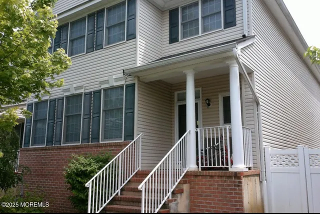 a view of a house with a window and wooden fence