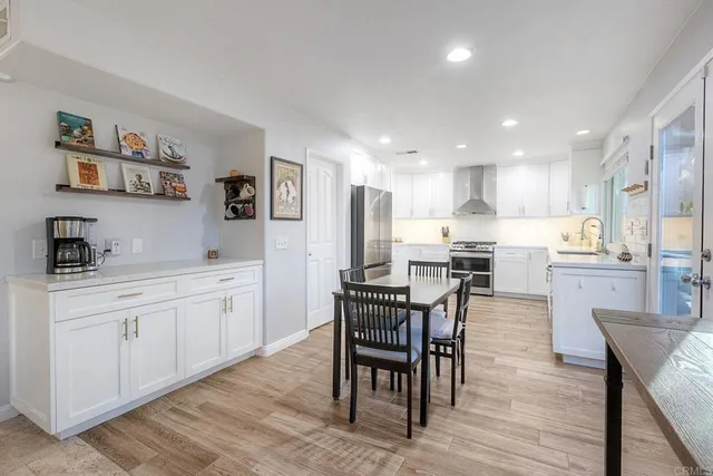 a kitchen with white cabinets and a stove with a sink