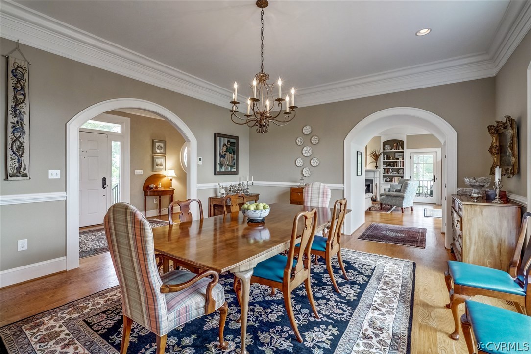 1571 Pine Hall Road Mathews, VA 23109 - Photo 13 of 48 a view of a dining room with furniture a chandelier and wooden floor