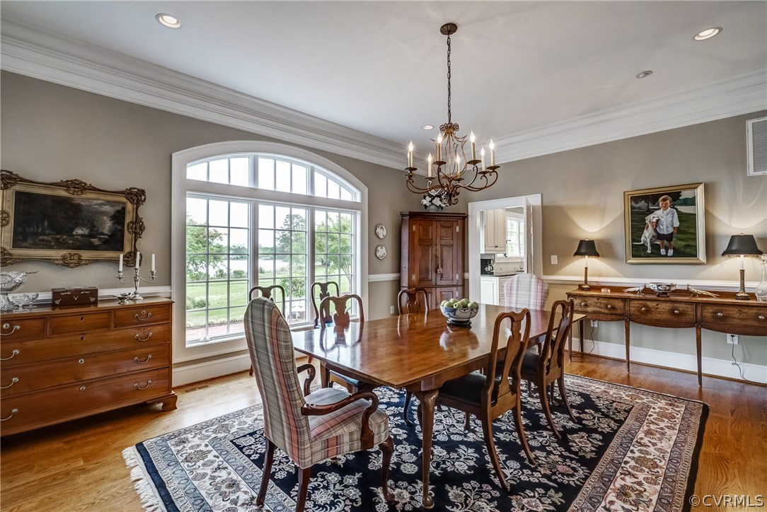 1571 Pine Hall Road Mathews, VA 23109 - Photo 14 of 48 a view of a dining room with furniture a rug and wooden floor