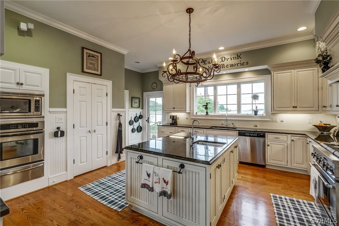 1571 Pine Hall Road Mathews, VA 23109 - Photo 15 of 48 a kitchen with stainless steel appliances granite countertop a stove a sink dishwasher a refrigerator and a wooden cabinets