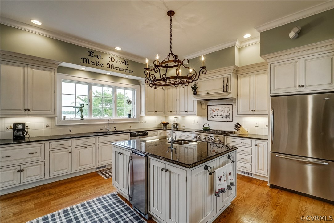 1571 Pine Hall Road Mathews, VA 23109 - Photo 17 of 48 a kitchen with stainless steel appliances granite countertop a sink stove and refrigerator