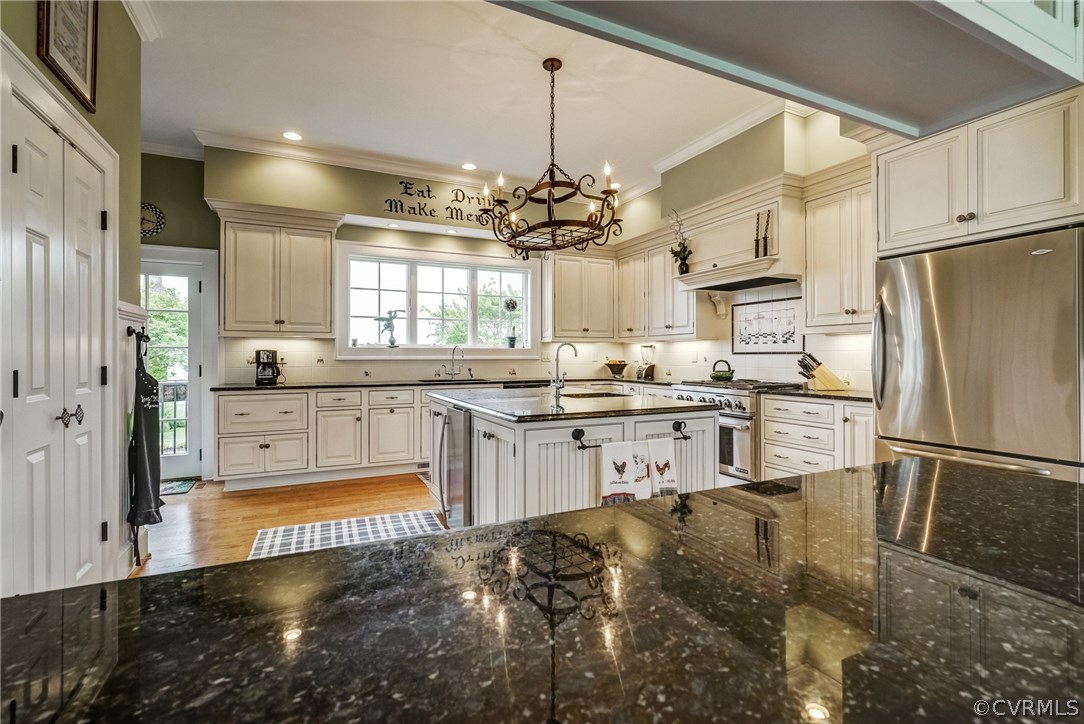 1571 Pine Hall Road Mathews, VA 23109 - Photo 18 of 48 a kitchen with stainless steel appliances granite countertop a refrigerator a sink dishwasher a stove and white cabinets with wooden floor