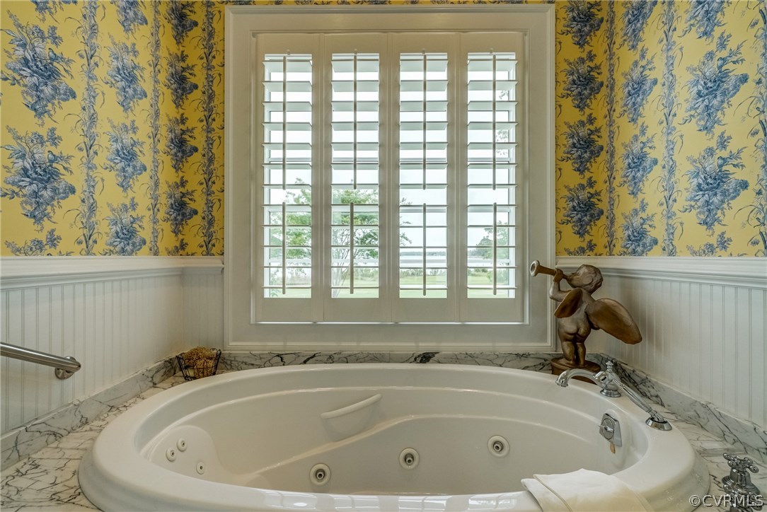 1571 Pine Hall Road Mathews, VA 23109 - Photo 22 of 48 a white bath tub sitting in a bathroom next to a window